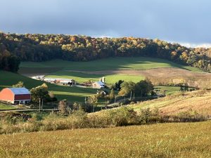 Dancing Star Farm Seed farm sitting in a valley surrounded by farm land, hay fields, and trees